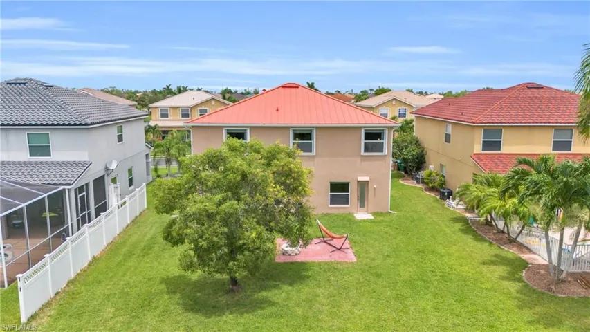 Back of property featuring a yard