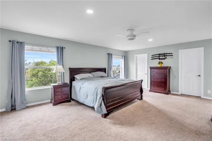 Bedroom with carpet and ceiling fan