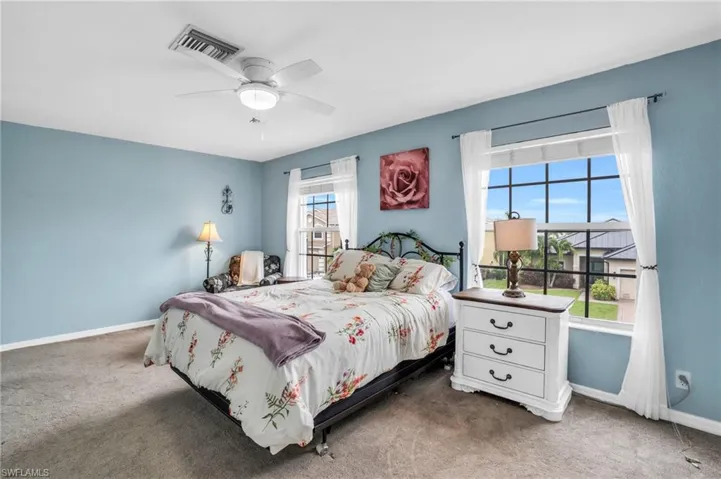 Carpeted bedroom with ceiling fan