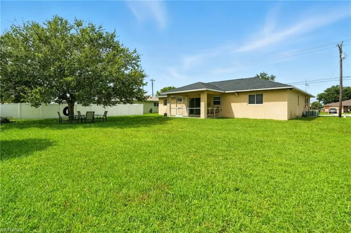 Rear view of property with stucco siding
