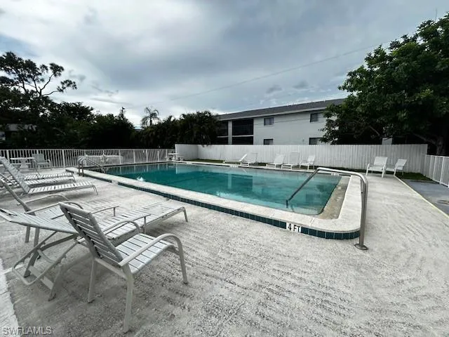Community pool featuring a patio