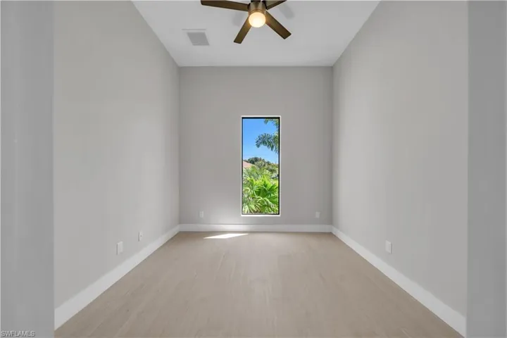 Unfurnished room featuring a ceiling fan and light wood-style flooring