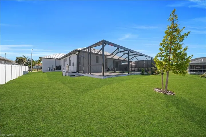 Back of property featuring a sunroom, a lanai, and a pool