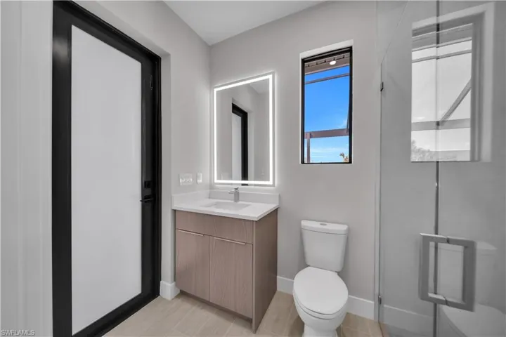Bathroom featuring vanity and a stall shower