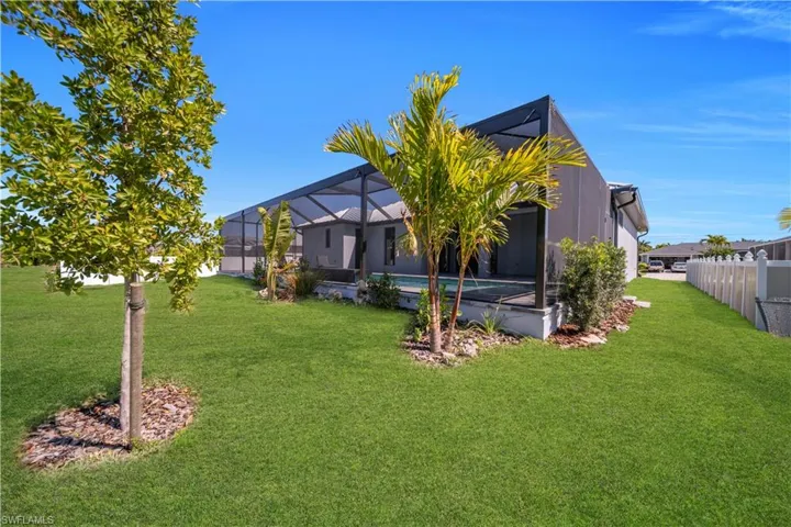 Rear view of property featuring a sunroom and glass enclosure