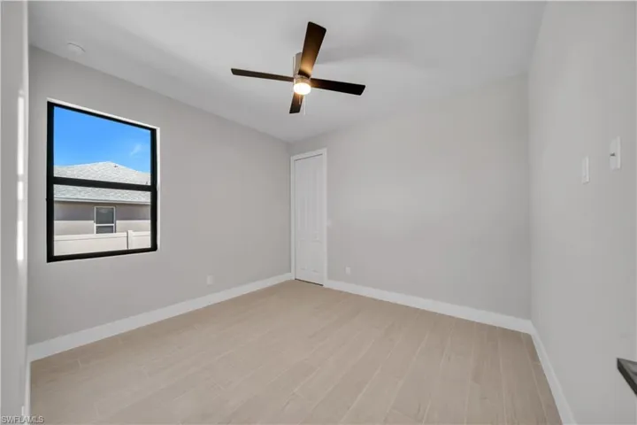 Spare room featuring light wood-type flooring and a ceiling fan