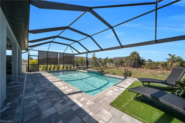 Swimming pool featuring a sunroom, a lanai, and a patio area