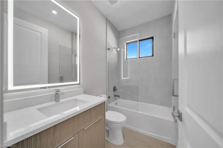 Bathroom with vanity and bathing tub / shower combination