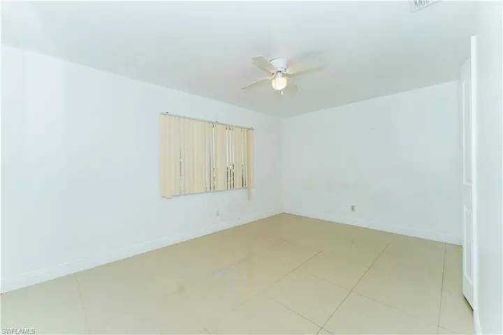 Unfurnished room with baseboards and a ceiling fan
