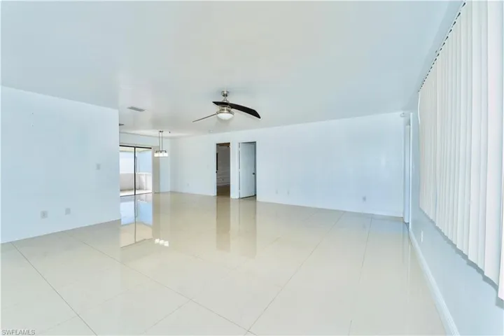 Spare room with a ceiling fan and light tile patterned floors