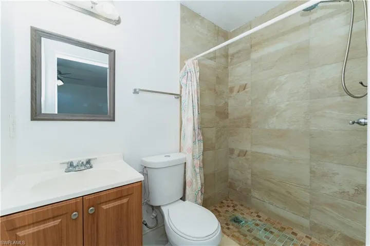 Full bathroom with a stall shower and vanity