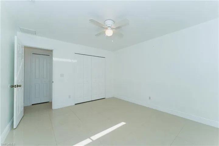 Unfurnished bedroom featuring a closet and ceiling fan