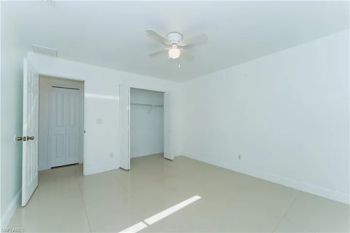 Unfurnished bedroom with a closet and a ceiling fan