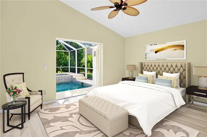 Primary bedroom with plank tile flooring, vaulted ceilings and French doors leading to the pool.