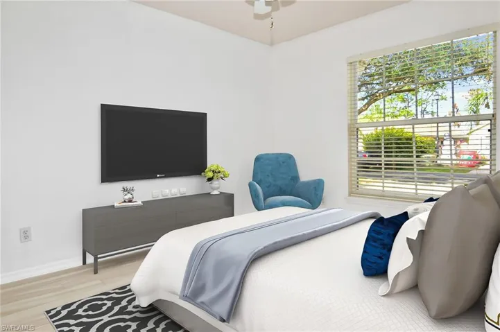 Guest bedroom featuring plank tile flooring