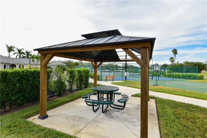 View of property's community with a gazebo, tennis court, and basketball court