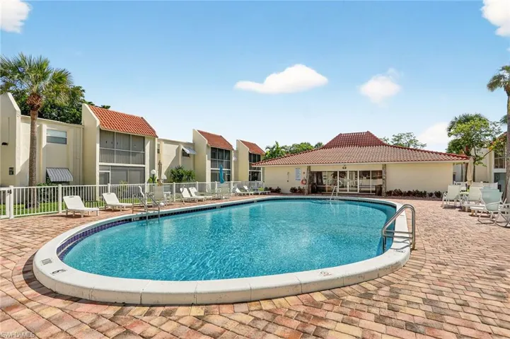 Community pool with a patio