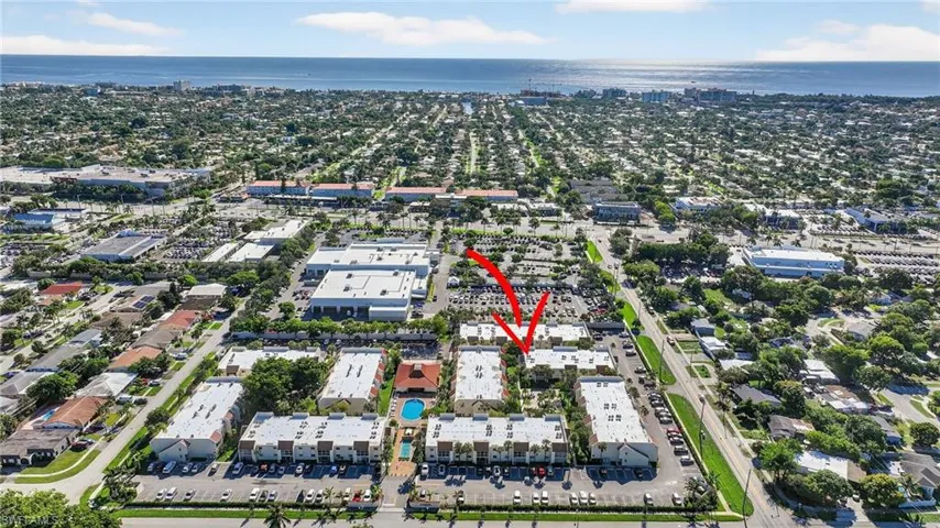 Aerial view of property and surrounding area featuring nearby urban area
