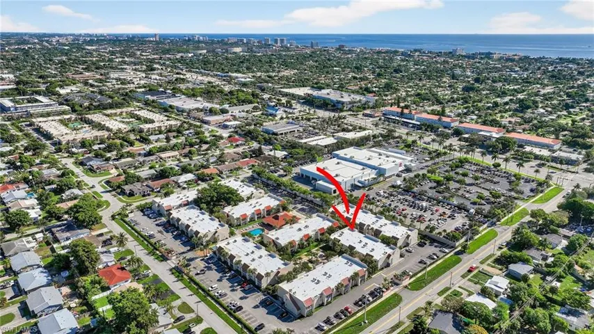 Aerial view of property and surrounding area with nearby urban area