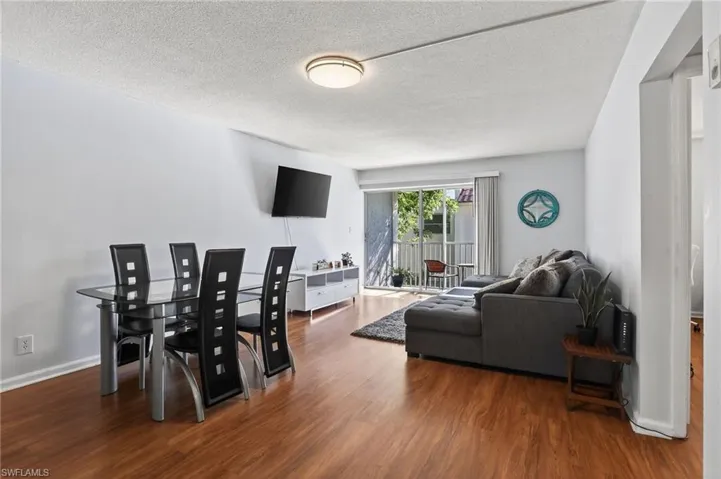 Dining space featuring wood finished floors and a textured ceiling