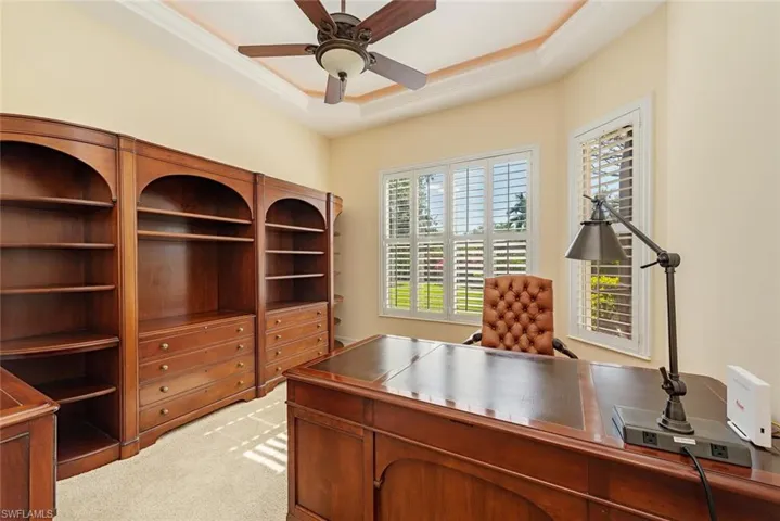 Office / den with plenty of light and views of the backyard and golf course