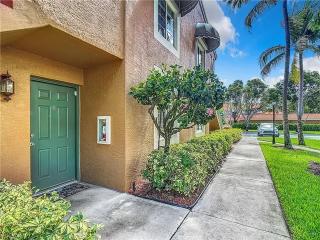 View of exterior entry feauring a lawn