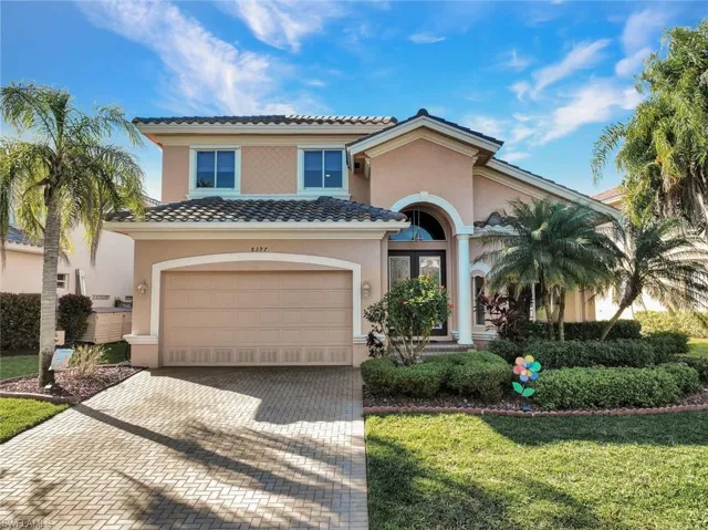 Mediterranean / spanish-style house with a front yard and a garage