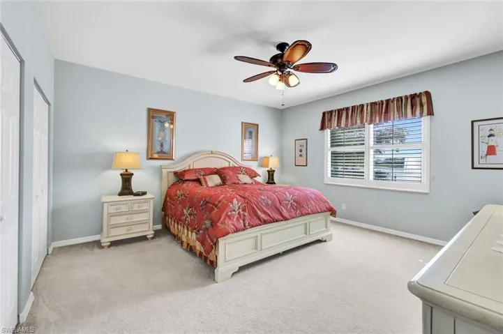MASTER BEDROOM Bedroom with a closet, ceiling fan, and light carpet