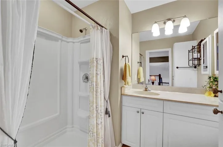 Bathroom featuring vanity and a shower with shower curtain