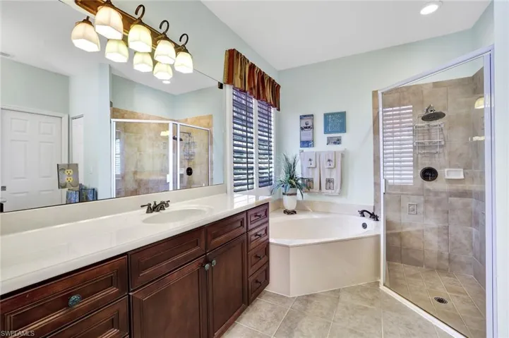 MASTER BATH Bathroom featuring vanity, tile patterned floors, and shower with separate bathtub