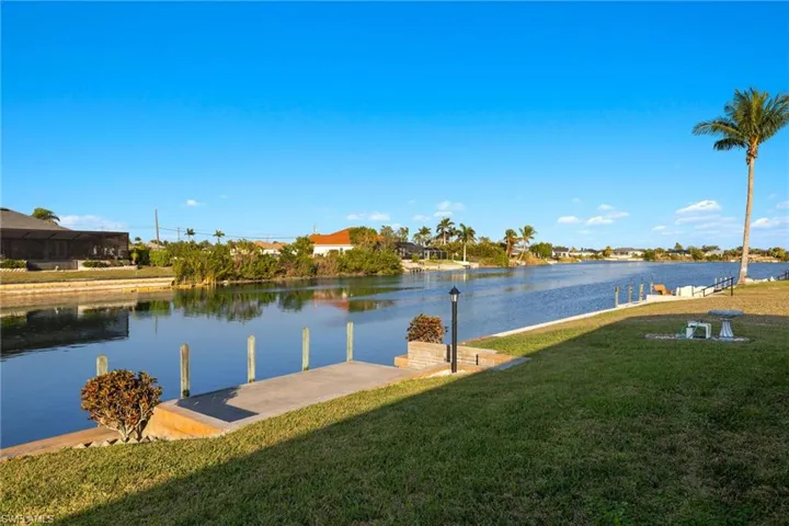 Dock area featuring a water view and a yard
