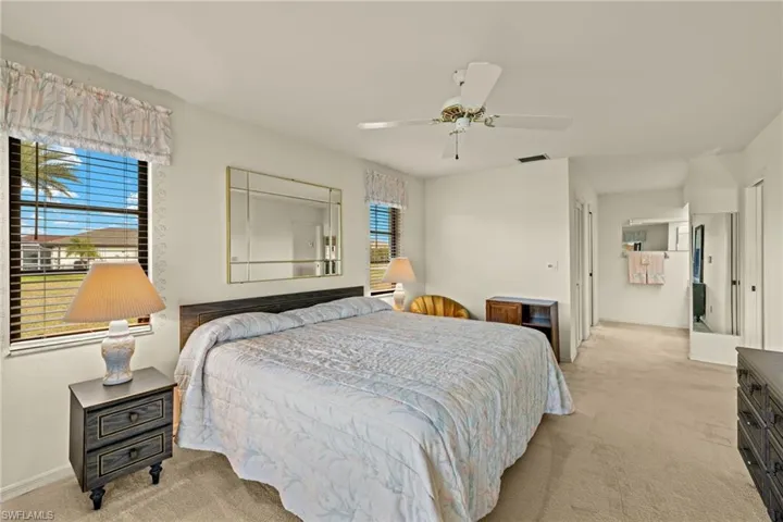 Carpeted bedroom with ceiling fan