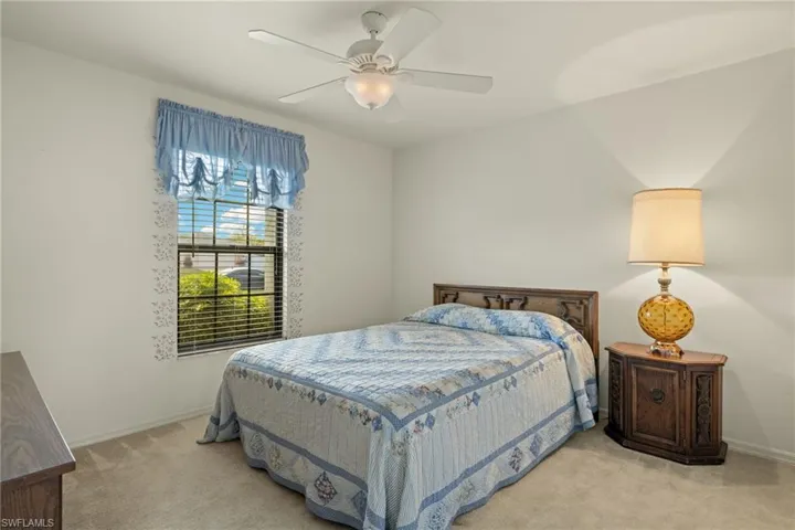 Bedroom with light colored carpet and ceiling fan