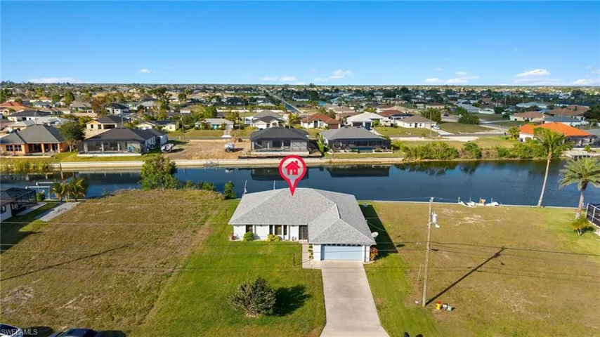 Birds eye view of property with a water view