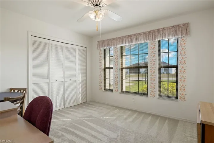 Carpeted office with ceiling fan