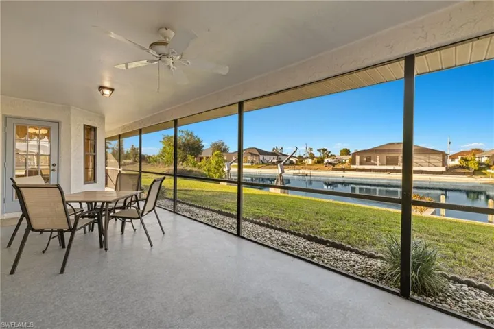 Sunroom featuring a water view and ceiling fan