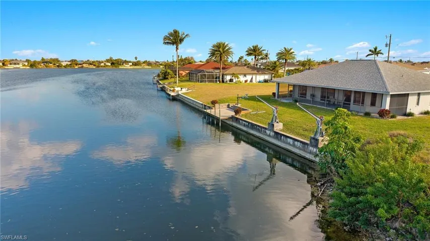 Dock area featuring a water view and a yard