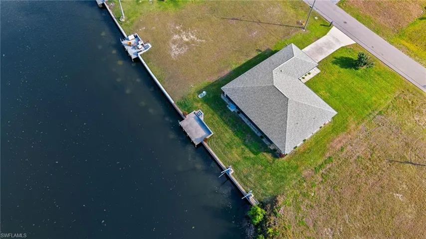 Birds eye view of property with a water view
