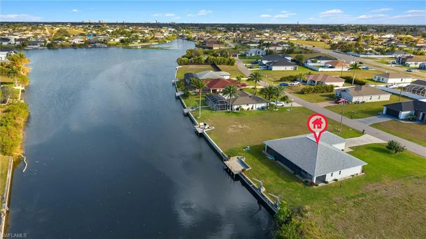 Birds eye view of property with a water view