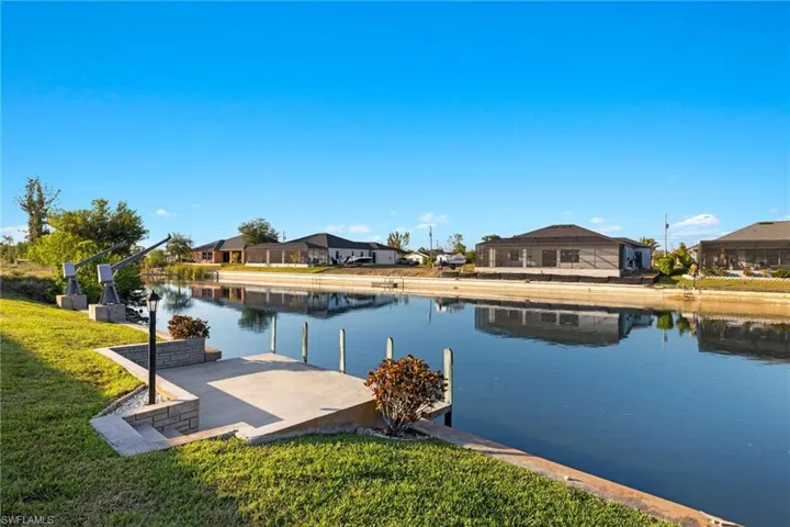 Dock area featuring a water view and a yard