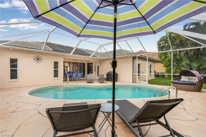 View of swimming pool featuring a lanai and a patio