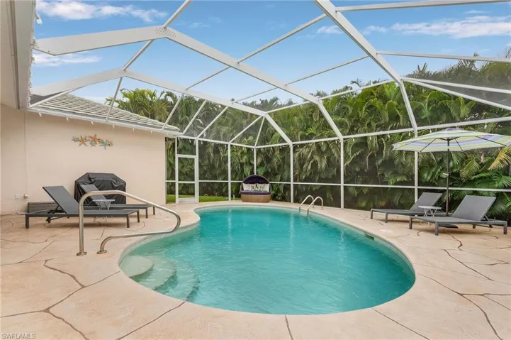 View of swimming pool featuring a lanai and a patio