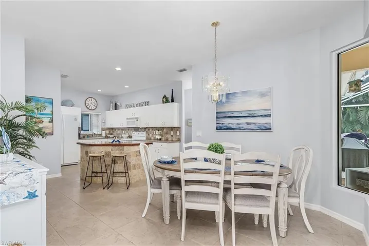Tiled dining space with an inviting chandelier