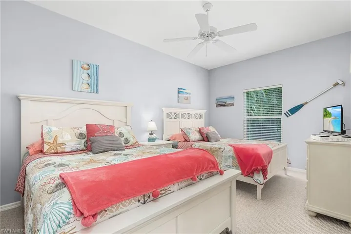 Carpeted bedroom featuring ceiling fan