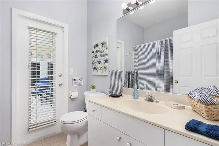 Bathroom with tile flooring, toilet, and vanity