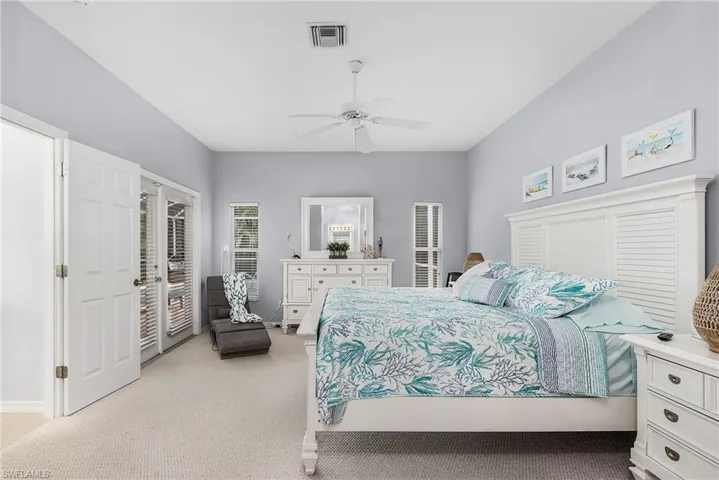 Bedroom with access to outside, ceiling fan, and light colored carpet