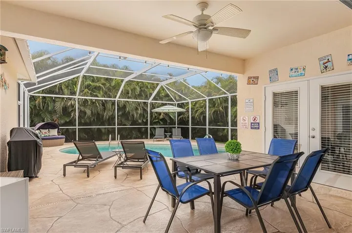 Sunroom / solarium featuring plenty of natural light, ceiling fan, and french doors