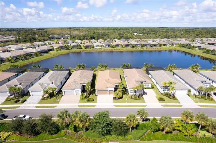 Aerial view of residential area featuring a large body of water