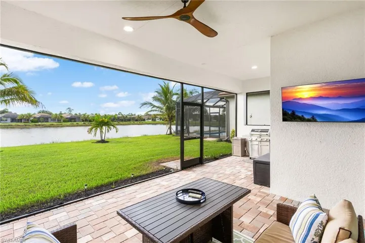 Sunroom featuring a patio area, ceiling fan, and area for grilling