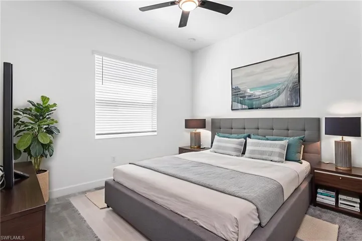 Bedroom with a ceiling fan and baseboards